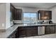 Modern kitchen with double sink, granite counters and stainless steel appliances at 9830 Wild Coyote Ct, Las Vegas, NV 89141