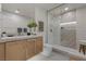 Bright bathroom featuring a glass enclosed shower, modern vanity, and neutral finishes at 2401 Driftwood Dr, Las Vegas, NV 89107