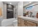 Modern bathroom featuring a tub and shower combo with gray tile and a wood vanity at 2401 Driftwood Dr, Las Vegas, NV 89107