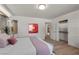 A bedroom with a view to an ensuite bath, closet and a large bed with pink pillows at 2401 Driftwood Dr, Las Vegas, NV 89107