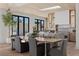Bright dining area featuring a wooden table, skylight, modern appliances, and a view of the front yard at 2401 Driftwood Dr, Las Vegas, NV 89107