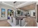 Open floor plan with large windows, light wood floors and modern light fixtures at 2401 Driftwood Dr, Las Vegas, NV 89107