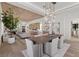 Open-concept dining room with wood floors and modern pendant lighting at 2401 Driftwood Dr, Las Vegas, NV 89107