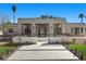 A modern home featuring a front yard, manicured trees, and a paver driveway at 2401 Driftwood Dr, Las Vegas, NV 89107