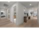 Light filled hallway with wood floors, white walls, and access to other rooms at 2401 Driftwood Dr, Las Vegas, NV 89107