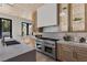Modern kitchen boasts stainless steel appliances, including a professional-grade range, and custom cabinetry at 2401 Driftwood Dr, Las Vegas, NV 89107