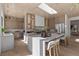Bright, open kitchen features a large island with seating, custom cabinets, and a stainless steel refrigerator at 2401 Driftwood Dr, Las Vegas, NV 89107