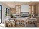 Modern kitchen featuring an island with seating, stainless steel appliances, wooden floors, and lots of cabinet space at 2401 Driftwood Dr, Las Vegas, NV 89107