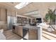 Contemporary kitchen featuring wooden cabinets, stainless steel appliances, a center island, and an open floor plan at 2401 Driftwood Dr, Las Vegas, NV 89107