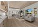 Bright, modern living room with wood floors, designer furnishings, and ample natural light at 2401 Driftwood Dr, Las Vegas, NV 89107