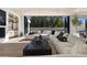 Open living room with comfortable seating and views to a lush backyard at 2401 Driftwood Dr, Las Vegas, NV 89107