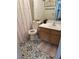 Cozy bathroom with decorative floor tiles, a vanity with a sink, and a shower-tub combo with floral shower curtain at 4764 Anchorage St, Las Vegas, NV 89147