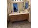 Bathroom features double sinks, a large mirror and a wood vanity providing storage, with ample lighting at 4764 Anchorage St, Las Vegas, NV 89147