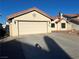Single story home with a stucco exterior, two car garage, and a red tile roof, accented by an American flag at 4764 Anchorage St, Las Vegas, NV 89147