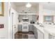 Cozy kitchen with gray cabinets, white appliances, and tile backsplash at 6201 E Lake Mead Blvd # 216, Las Vegas, NV 89156