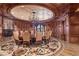 Elegant formal dining room with a large round table, intricate flooring, and a stunning coffered ceiling at 9101 Alta Dr # 1406, Las Vegas, NV 89145