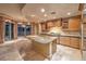 Gourmet kitchen features granite island, stainless steel appliances, and custom wood cabinetry at 9101 Alta Dr # 1406, Las Vegas, NV 89145