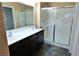 Bathroom boasts double sinks and a glass shower at 9869 Juno Hills St, Las Vegas, NV 89178