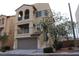 Two-story house with attached garage and balcony at 9869 Juno Hills St, Las Vegas, NV 89178