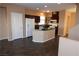 Modern kitchen featuring dark cabinets and an island at 9869 Juno Hills St, Las Vegas, NV 89178