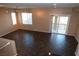 Living room features dark tile floors and balcony access at 9869 Juno Hills St, Las Vegas, NV 89178
