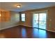 Living area with laminate wood floors and balcony access at 9869 Juno Hills St, Las Vegas, NV 89178