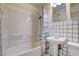 Bathroom with shower/tub combo, pedestal sink, and tiled walls at 120 Maple St, Henderson, NV 89015