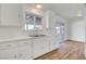 Kitchen features white cabinets, dual sink, and sliding door to backyard at 120 Maple St, Henderson, NV 89015