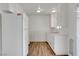 White kitchen with wood-look vinyl flooring and appliances at 120 Maple St, Henderson, NV 89015