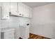 White kitchen with overhead cabinets and vinyl flooring at 120 Maple St, Henderson, NV 89015