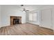 Living room featuring a brick fireplace and wood-look flooring at 120 Maple St, Henderson, NV 89015