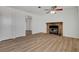 Living room with stone fireplace and wood-look floors at 120 Maple St, Henderson, NV 89015