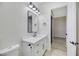 Modern bathroom with white vanity, quartz countertop, and black fixtures at 1928 Oliver Springs St, Henderson, NV 89052