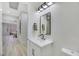 Modern powder room with white vanity and black accents at 1928 Oliver Springs St, Henderson, NV 89052