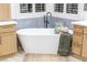 Relaxing bathroom with a freestanding bathtub and light wood cabinets at 1928 Oliver Springs St, Henderson, NV 89052