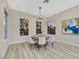 Bright dining room with a round wooden table, chandelier, and large windows at 1928 Oliver Springs St, Henderson, NV 89052