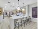 Modern kitchen with large island, stainless steel appliances, and white quartz countertops at 1928 Oliver Springs St, Henderson, NV 89052