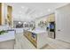 Spacious kitchen featuring a large island with quartz countertops and light wood cabinets at 1928 Oliver Springs St, Henderson, NV 89052