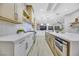 Modern kitchen with white and wood cabinets, a large island, and stainless steel appliances at 1928 Oliver Springs St, Henderson, NV 89052