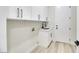 Bright laundry room with white cabinets, a utility sink, and modern finishes at 1928 Oliver Springs St, Henderson, NV 89052