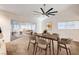 Bright dining area features large windows, a modern ceiling fan, and seamless access to the spacious living room at 2240 Mohigan Way, Las Vegas, NV 89169