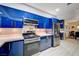 Modern kitchen with blue cabinets and stainless steel appliances at 2240 Mohigan Way, Las Vegas, NV 89169