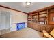 Library features a full wall of custom shelving with views to the hall, and blue art panel at 2240 Mohigan Way, Las Vegas, NV 89169