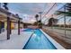 Backyard swimming pool with modern fire feature and surrounding greenery at dusk at 2240 Mohigan Way, Las Vegas, NV 89169