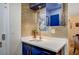 Stylish wet bar with blue cabinets and a quartz countertop at 2240 Mohigan Way, Las Vegas, NV 89169