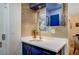 Chic wet bar area with blue cabinets, quartz countertop, and decorative backsplash at 2240 Mohigan Way, Las Vegas, NV 89169