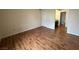 Bright bedroom with wood-look floors and access to bathroom at 2606 S Durango Dr # 172, Las Vegas, NV 89117