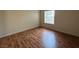 Bright bedroom with wood-look floors and large window at 2606 S Durango Dr # 172, Las Vegas, NV 89117