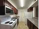 Galley kitchen with stainless steel appliances and wood cabinets at 2606 S Durango Dr # 172, Las Vegas, NV 89117