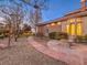 Backyard oasis with a stone pathway leading to a fire pit near the house at 3 Palmbrook Ln, Henderson, NV 89052